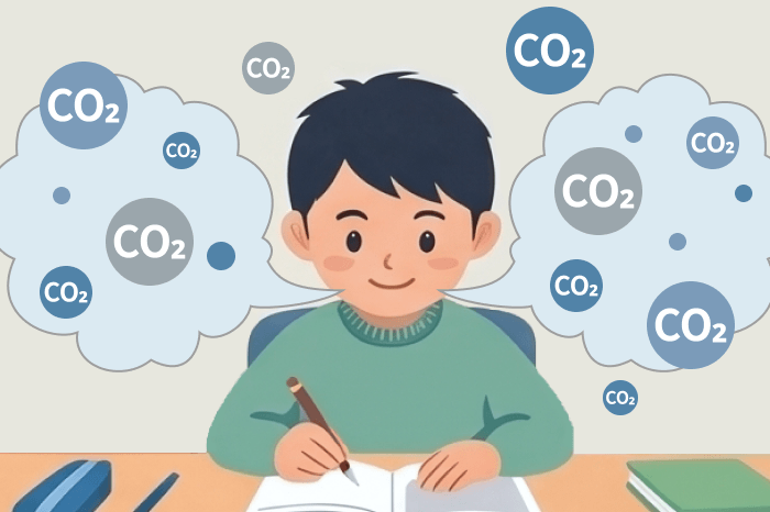 机に向かう子どもと、呼気で発生するCO₂粒子のイメージ